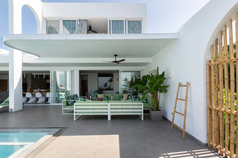 Modern interior hallway with natural stone accent wall and designer details at C Villa, Koh Samui