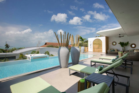 Daytime pool view with sun loungers and modern white villa architecture at C Villa, Koh Samui rental