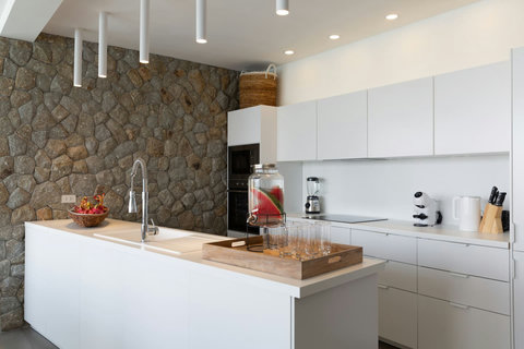Sleek modern kitchen with stone backsplash and premium appliances at C Villa, Koh Samui vacation rental