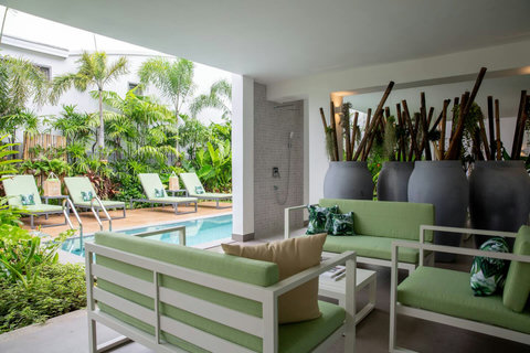 Pool deck lounge area with garden sofas overlooking the private pool at C Villa, Koh Samui estate