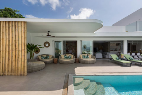 Covered poolside terrace with comfortable daybed loungers at C Villa, luxury Koh Samui holiday retreat