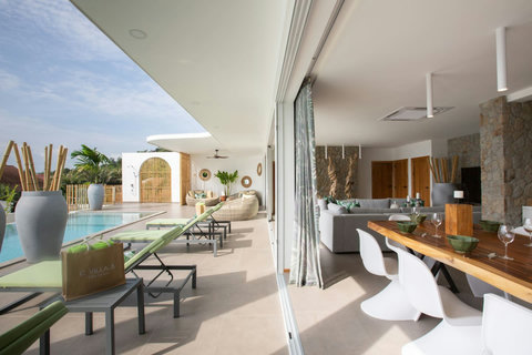 Spacious open-plan living and dining area with garden views at C Villa, 6-bedroom Koh Samui vacation home
