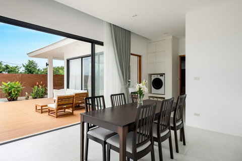 Covered outdoor dining terrace with pool views Samui luxury villa