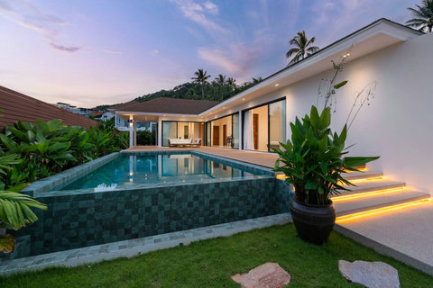 Villa at twilight with illuminated pool Mark Marlow Koh Samui Thailand