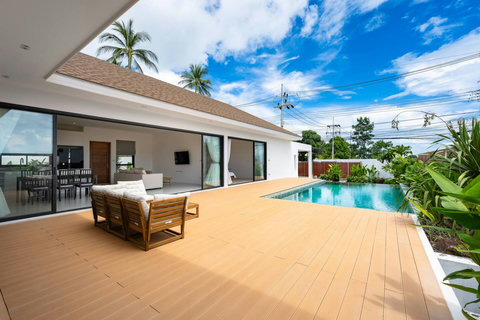 Villa exterior with infinity pool and outdoor lounge areas Samui