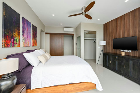 Luxurious master bathroom with double vanities, backlit mirrors, and a clean modern design.