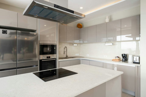 Fully equipped modern kitchen flowing into a spacious living and dining area