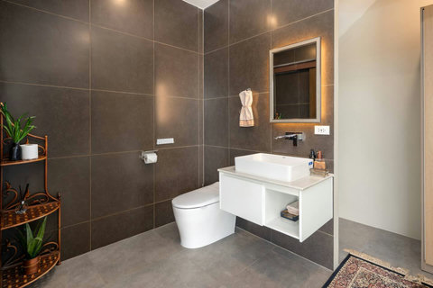 leek guest bathroom with warm lighting and contemporary design