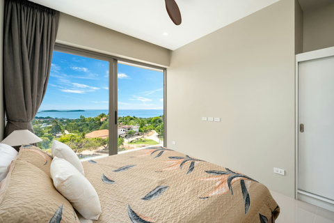 Modern bathroom with a spacious walk-in shower, sleek vanity, and warm ambient lighting."