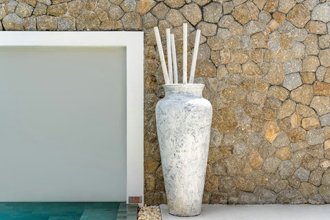 Decorative stone wall feature with pool backdrop Villa Jasmine Koh Samui luxury villa Thailand tropical design