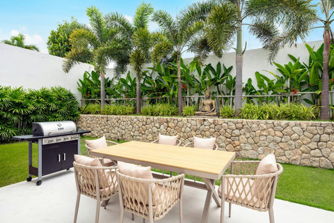 Outdoor dining area with BBQ and tropical garden Villa Jasmine Koh Samui luxury private pool villa Thailand