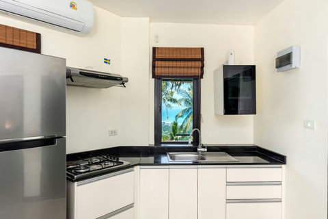 Fully equipped kitchen with garden views, perfect for a relaxing Koh Samui stay.