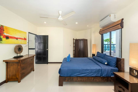 Spacious king bedroom with garden views and tranquil hillside ambience.