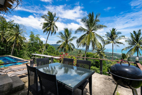 Private terrace dining with panoramic views of Nathon’s coastline and Koh Samui’s tranquil hills.