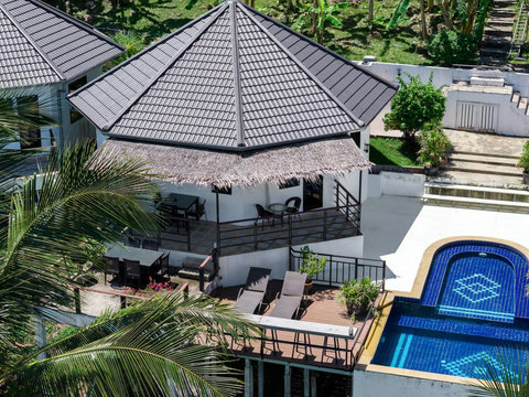 Relax by the hillside pool and shaded pavilion with panoramic island scenery.