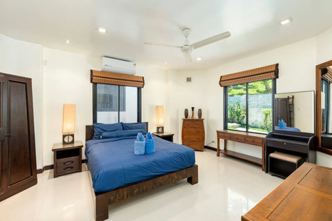 Large master bedroom with king-size bed and serene garden views