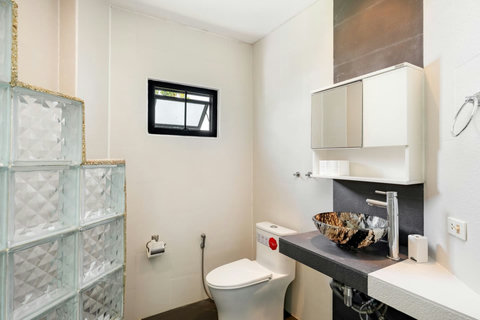 Bright and modern bathroom with tropical design elements