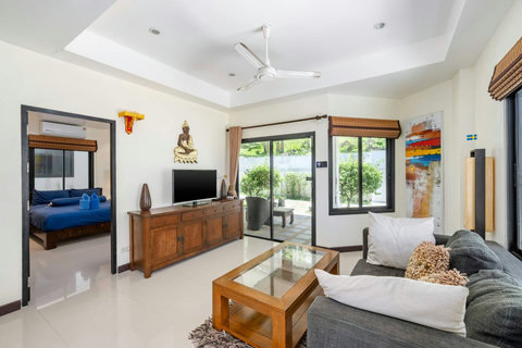 Spacious open-plan living area with natural light and modern décor.