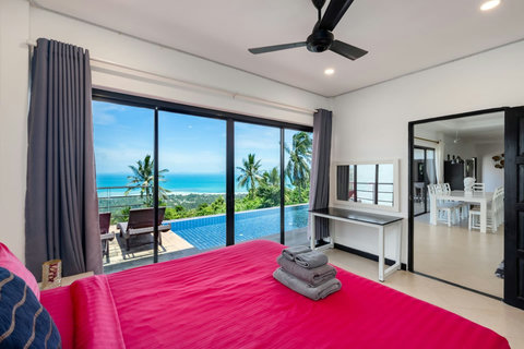 Master bedroom with king bed and sweeping views of the private pool and ocean.