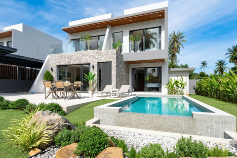 Villa Solaria pool area with lush tropical landscaping and outdoor furniture in Plaileam