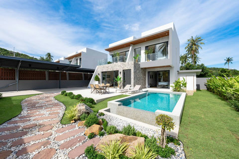 Modern Villa Solaria exterior with lush tropical landscaping and private pool in Plaileam