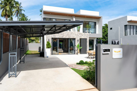 Covered outdoor terrace with modern architectural design and tropical garden views