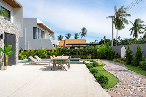 Peaceful garden pathway leading to Villa Solaria entrance with tropical landscaping