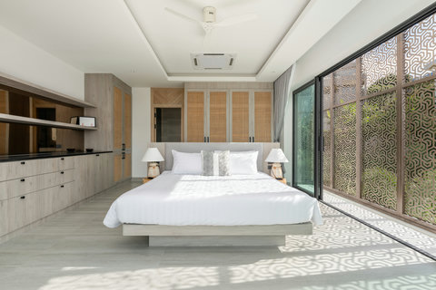 Spacious master bedroom with elegant textured accent wall