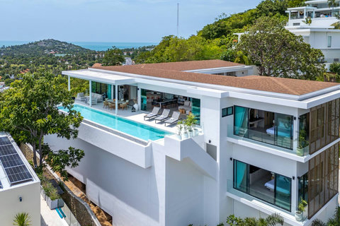 Multi-level villa exterior surrounded by lush tropical gardens