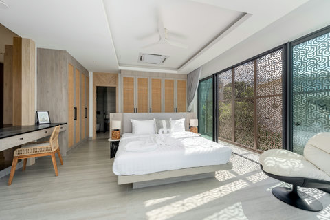 Serene bedroom with dramatic vaulted wooden ceiling