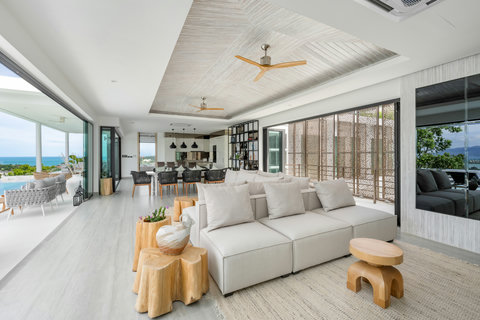 Spacious covered outdoor sala with plush sofas and sea views