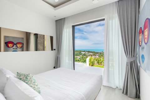 Airy bedroom with vaulted ceiling and stunning sea views