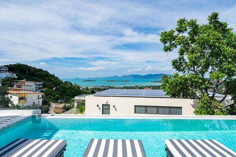 Inviting pool terrace with loungers and tropical island views