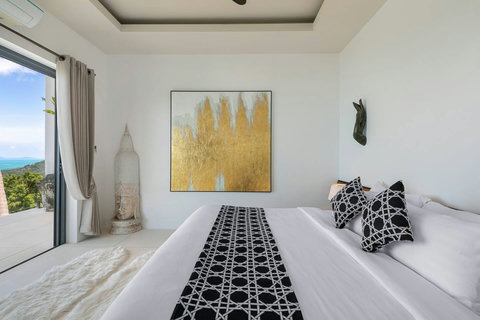 Serene master bedroom with plush king bed contemporary art and mountain garden views - Villa Caprice 5-bedroom luxury retreat Santi Thani Bangpor Mae Nam Koh Samui