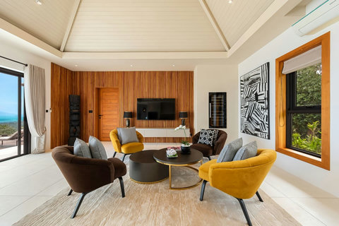 Bright living room with comfortable seating panoramic mountain views and entertainment system - Villa Caprice 5-bedroom luxury retreat Santi Thani Bangpor Mae Nam Koh Samui
