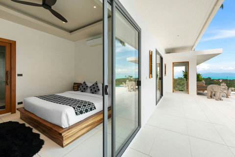 Spacious ensuite bedroom with private ocean view terrace and glass doors - Villa Caprice 5-bedroom luxury retreat Santi Thani Bangpor Mae Nam Koh Samui