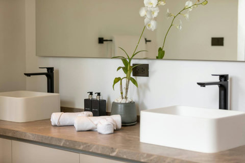 Luxurious ensuite bathroom vanity with elegant stone countertop modern fixtures and natural light - Villa Caprice 5-bedroom luxury retreat Santi Thani Bangpor Mae Nam Koh Samui