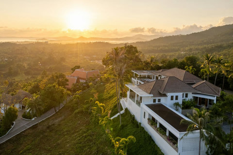 Spectacular aerial sunset view of Villa Caprice nestled in lush tropical hillside - 5-bedroom luxury retreat Santi Thani Bangpor Mae Nam Koh Samui