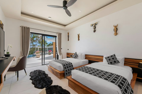 Comfortable twin bedroom with garden terrace access and contemporary furnishings - Villa Caprice 5-bedroom luxury retreat Santi Thani Bangpor Mae Nam Koh Samui