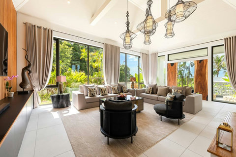 Spacious open-plan living room with elegant furnishings tropical garden views and Balinese decor - Villa Caprice 5-bedroom luxury retreat Santi Thani Bangpor Koh Samui