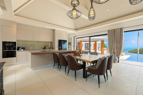 Elegant open-plan dining area with stunning ocean views and pool terrace access - Villa Caprice 5-bedroom luxury retreat Santi Thani Bangpor Mae Nam Koh Samui