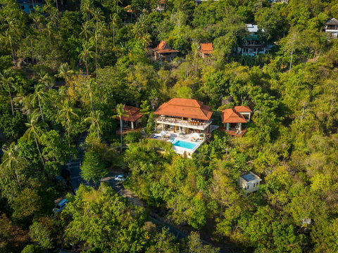 Aerial view of Villa Soluna's red-roofed compound with tropical gardens and seaview setting in Koh Samui