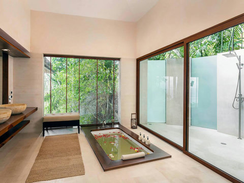 Modern glass-walled villa opening to lush tropical gardens - indoor-outdoor living at Villa Soluna Koh Samui