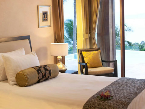Cozy second bedroom with traditional Balinese shutters and warm earth-tone bedding at Villa Soluna Koh Samui