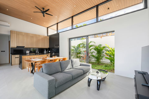 Living Room - Comfortable Grey Sofa with Pool & Garden Views