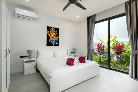Guest Bedroom - Clean White Decor with Ceiling Fan & Garden Views