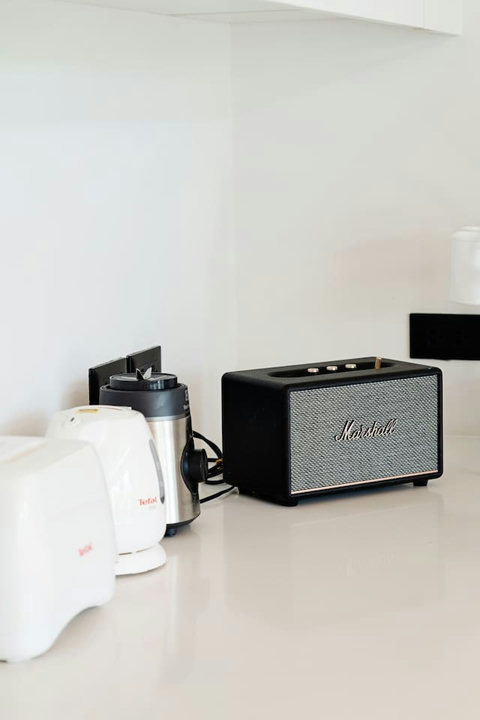In-villa amenities with Bluetooth speaker and kettle for guest convenience