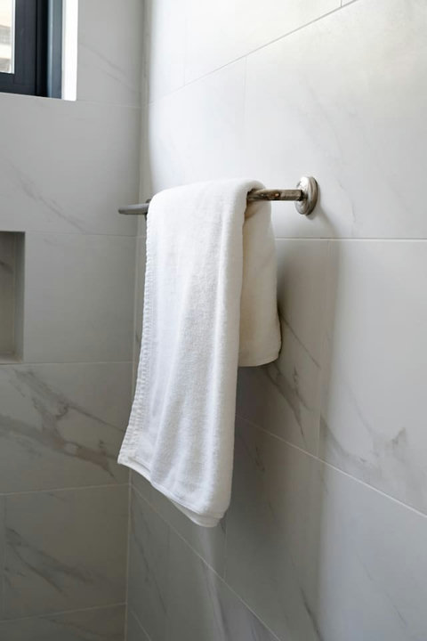 Bathroom with fresh towels and marble finishes
