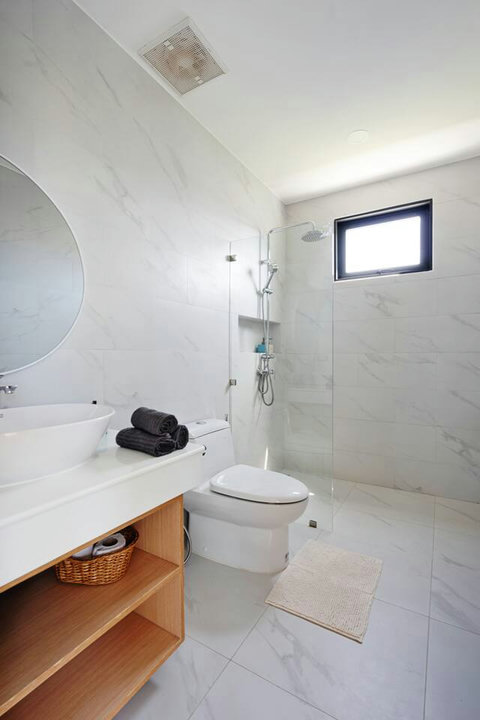 Ensuite bathroom with rain shower, marble walls and modern fixtures