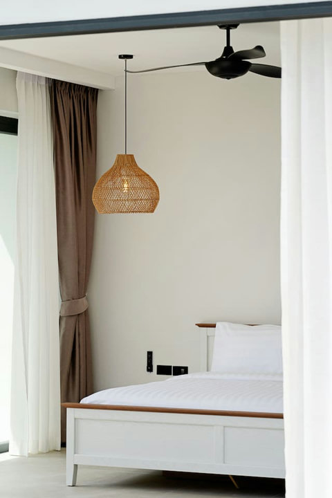Serene bedroom with plush bedding, soft curtains and natural light